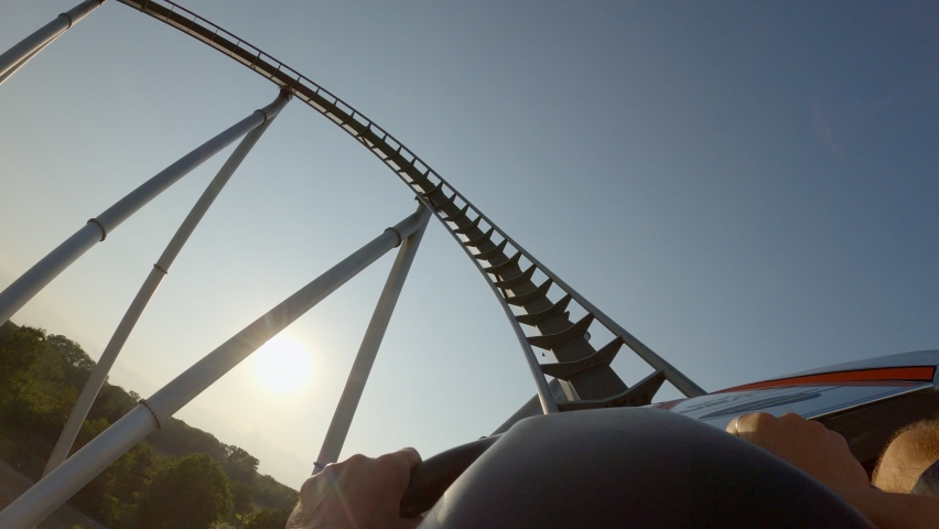 First person view riding a roller coaster in an amusement park  | Shutterstock HD Video #1089728221