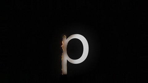 The letter p smolders and burns on a black background, the letter is on fire