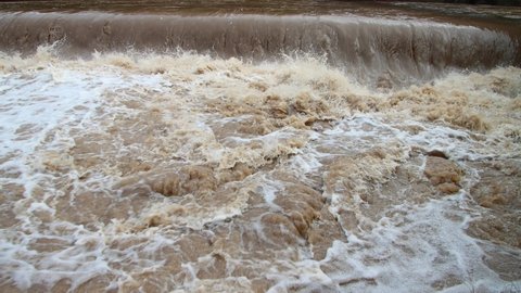 Low angle view of splashing water under a weir, close up