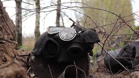 Ukraine, Yasnohorodka, Kyiv Oblast - 04.26.2022: Broken gas mask of the Russian army on the ground. Consequences of Russia's military attack on Ukraine.