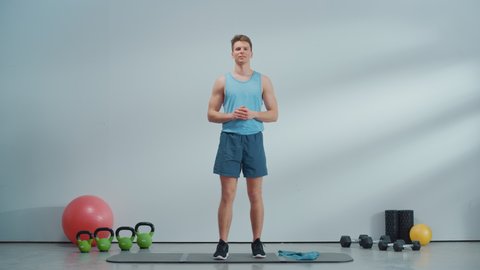 Fitness Course Video Stream with Young Athletic Personal Trainer Explaining Core Strengthening Workout Routine with a Rubber Band. Fit Online Coach Showing Exercises for Beginners.