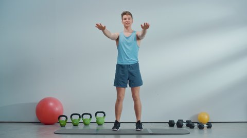 Fitness Course Internet Video with Young Athletic Personal Trainer Explaining Cardio Workout Routine Starting with High Knees Exercise. Fit Online Coach Showing How to Lose Body Weight.