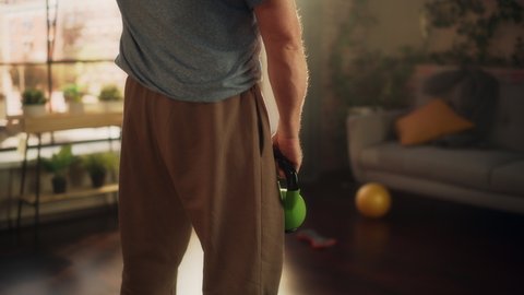Senior Man Feeling Uncomfortable Sudden Back Pain During Morning Workout, While Exercising with Heavy Weights at Home. Middle Aged Male Grabbing His Back to Ease the Pain.