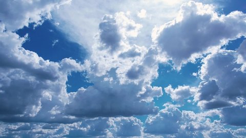 Dreamscape of fluffy clouds in the blue sky. Aerial drone shot of a very cloudy landscape. Time-lapse shot. Concept of passage of time and transformation. Serenity and calm on a sunny spring day.