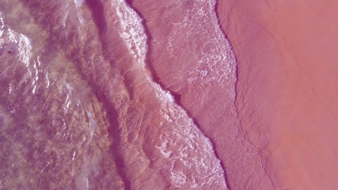 Aerial view of drone. Scene of Pink beach top view beach and pink seawater on sandy beach in summer. Nature and travel concept.