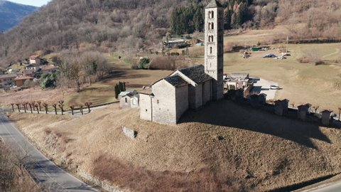 Aerial view of the small ancient church of St. Alexander, an example of the widespread Romanesque rural architecture of XII century in the Como area (Italy).