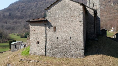 Aerial view of the bell tower of the small ancient church of St. Alexander, an example of the widespread Romanesque rural architecture of XII century in the Como area (Italy).