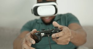 Black man in VR glasses playing video games