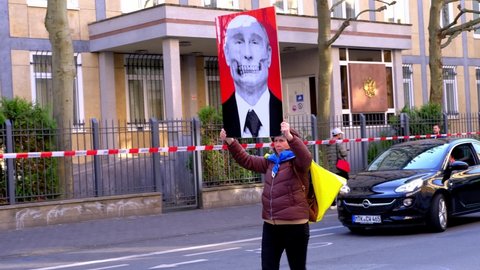 people support Ukraine, protesters walk with Ukrainian flag and portrait of Putin rally against Russia's invasion of Ukraine near Consulate of Russia, concept no war, Frankfurt - March 2022