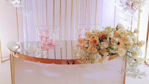 A festive table with fresh flowers and glasses. Everything for a festive event
