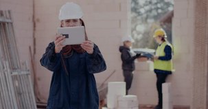 Female civil engineer on video call showing construction site