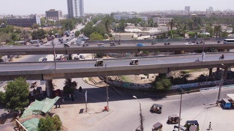 Drones goes right to left showing streets bridges in a metropolitan area of Karachi. Karachi, Pakistan. 25th March 2021