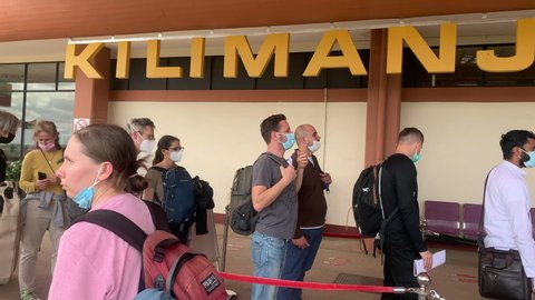 Kilimanjaro International Airport, Tanzania 12.23.2021 A queue of arriving passengers and waiting for document checks at Kilimanjaro Airport Health screening table. Health screening for passengers