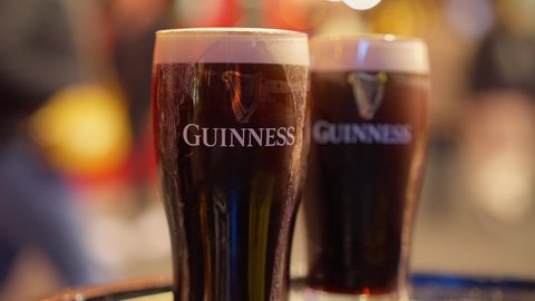Fresh cold Guinness beer at an Irish Pub in Dublin - CITY OF DUBLIN, IRELAND - APRIL 20, 2022