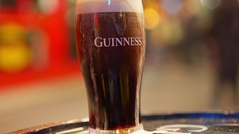 Fresh cold Guinness beer at an Irish Pub in Dublin - CITY OF DUBLIN, IRELAND - APRIL 20, 2022