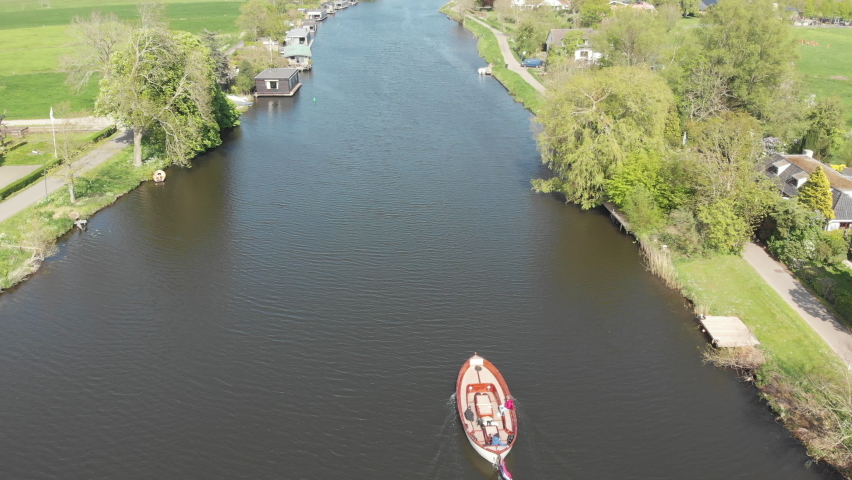 Sloop sailing on the river Vecht in Utrecht, the Netherlands (drone) Royalty-Free Stock Footage #1089741749