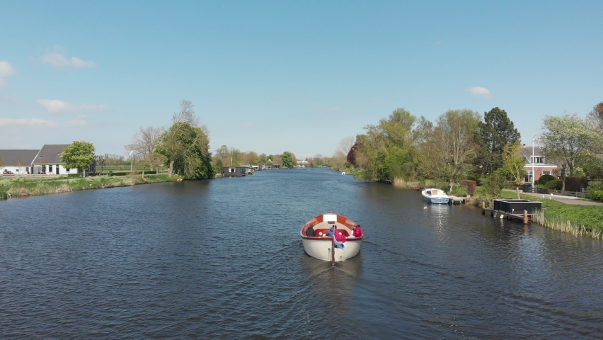 Sloop sailing on the river Vecht in Utrecht, the Netherlands (drone) Royalty-Free Stock Footage #1089742343