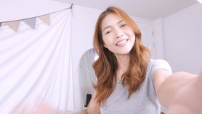 Young Asian woman teenager speaking on a video call, vlogger using smartphone talking at camera webcam online, selfie call, record lifestyle vlog, blogger online streaming, communicating with a friend