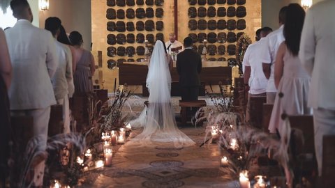 Catholic ceremony for wedding with quiet audience sitting down in Playa del Carmen, Quintana Roo, Mexico on January 20th 2022