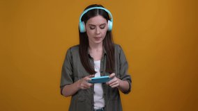 Lady use headset win video game device isolated vibrant color background