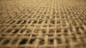 Textured linen or cotton burlap with binding brown fibres. Rough burlap sack texture. Weave woven sackcloth with natural fiber close up. Macro. Rustic vintage view. Slow motion ready 59.94fps. - Powered by Shutterstock - Get 15% off with code: PIKWIZARD15