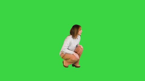 Charming girl playing and hugging with her bichon frise on a Green Screen, Chroma Key.