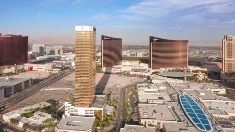 Las Vegas Strip, USA Apr. 2022. Impressive shiny golden Trump hotel with Encore and WYNN hotels on motion background. Scenic view on world famous 5 stars resorts and hotels in gentle golden hour light