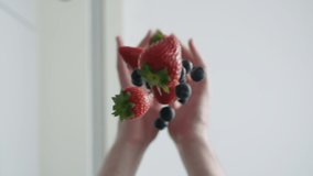 Male hands drops fresh berries into water, washing sweet strawberries and blueberries in process of cooking in kitchen underwater view, bottom up, slow motion view from below - Powered by Shutterstock - Get 15% off with code: PIKWIZARD15