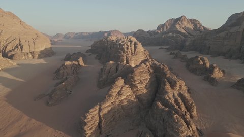 Stunning desert landscape and rock formations from Wadi Rum desert in Jordan during sunset time, aerial view