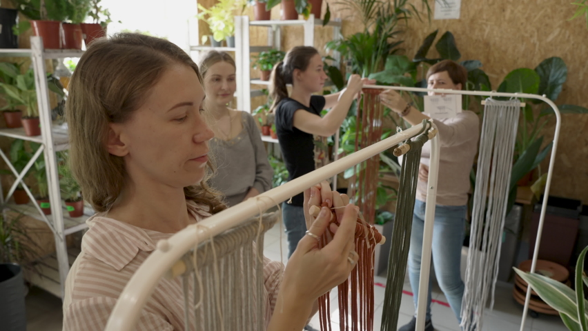 Group of women attending art class. Female students and teacher makes home decor in Boho style in workshop together. Weaves handmade macrame at art school studio. Creativity, people education | Shutterstock HD Video #1089752301