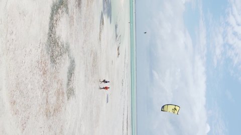Vertical video kitesurfing near the shore of Zanzibar, Tanzania, aerial view