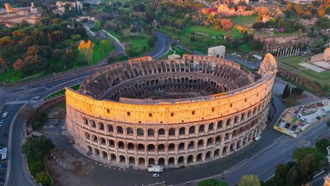 ancient Roman monument, flying around Coliseum in Rome at sunrise, iconic tourist destination in Rome, Italy, world heritage site. High quality 4k footage