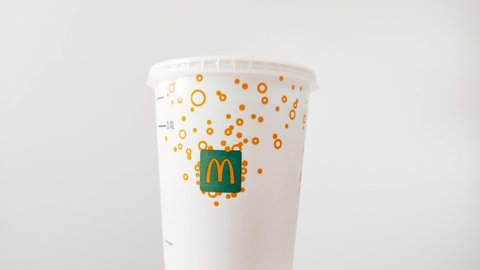 Pruszcz Gdanski, Poland - April 28, 2022: Detail of rotation McDonald's cup. McDonalds plastic cup for soda drink.