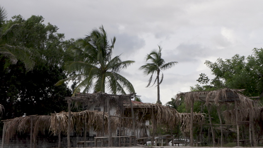 Abandoned beach hut on the beach with wind and gray sky , horror stressful mood