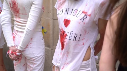 28.04.2022- Barcelona, Spain. Casa de Rusia. protest demonstration by Ukrainian activists against raping woman and kids during war in Ukraine. girls in blood hands tied imitating victims of violence