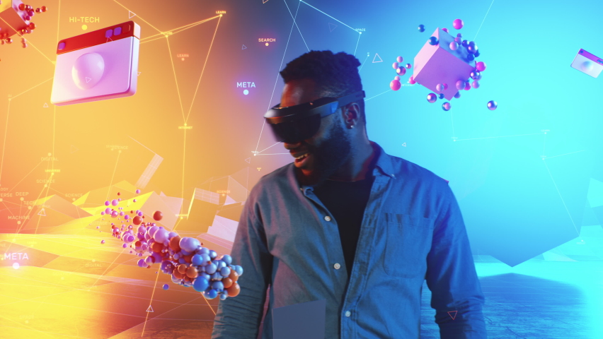 African American man putting on VR headset and emotionally looking around to the abstract cyber world and animated particles and social media icons flying around him of the meta universe metaverse. | Shutterstock HD Video #1089757263