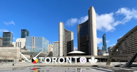 Toronto, Canada - April 29, 2022: Establishing shot in the Nathan Phillips Square and the New City Hall 
