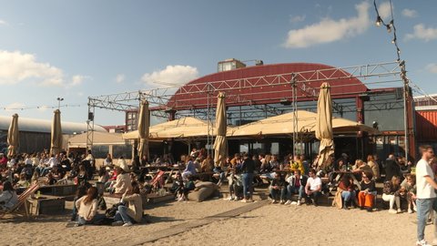 Amsterdam, Netherlands, April 25, 2022. Hipster bar at the beach by the river IJ.