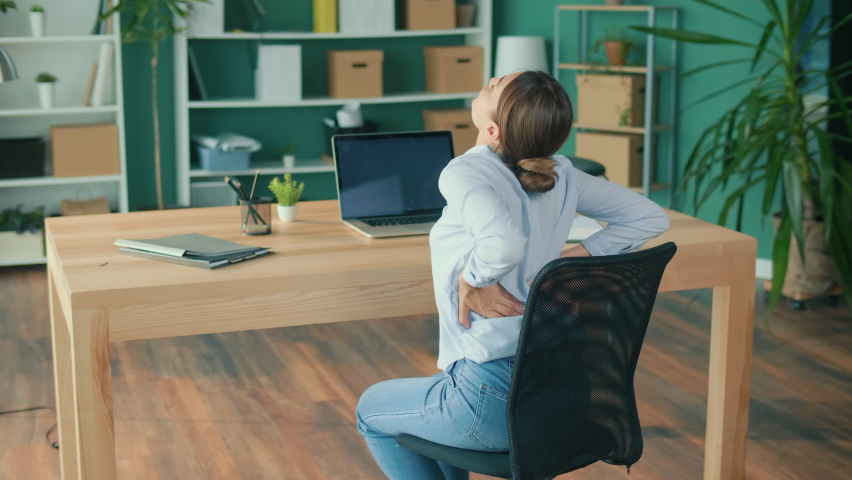Back View of Woman Feeling Tired of Long Sedentary Lifestyle,Rubbing Massaging Neck and Back to Ease the Injury.Female Experiencing Discomfort in a Result of Spine Trauma or Arthritis. Office Syndrome Royalty-Free Stock Footage #1089762269