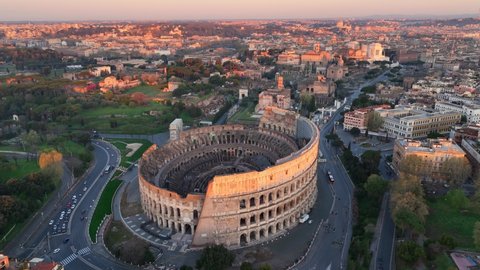 sunrise in Rome, capital of Italy, aerial view of Coliseum in Rome, iconic Italian landmark, monument of ancient Roman empire. High quality 4k footage