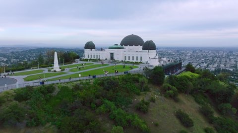 Los Angeles , California , United States - 04 28 2022: Aerial Shot of Griffith Observatory and Beautiful Los Angeles Hazy Skyline Ahead