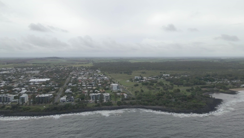 Ocean And Coastal Town On A Cloudy Day In Bundaberg, Queensland, Australia - aerial sideways