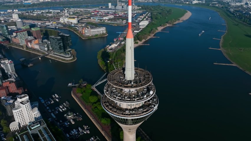 beautiful drone shot of the Rhine Tower in Düsseldorf at sunrise. The drone moves away from the Rhine Tower and opens the beautiful view of Rhine Royalty-Free Stock Footage #1089767741