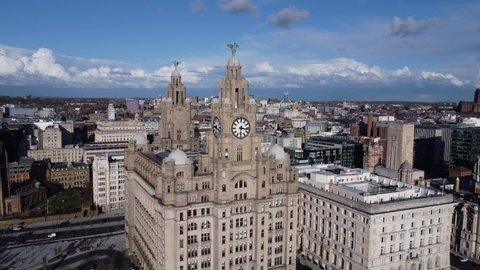 LIVERPOOL, UK - 2022: Aerial reveal and establishing view of the Royal Liver building in Liverpool