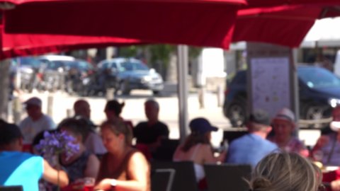 Blurred people eating in restaurant outdoor.