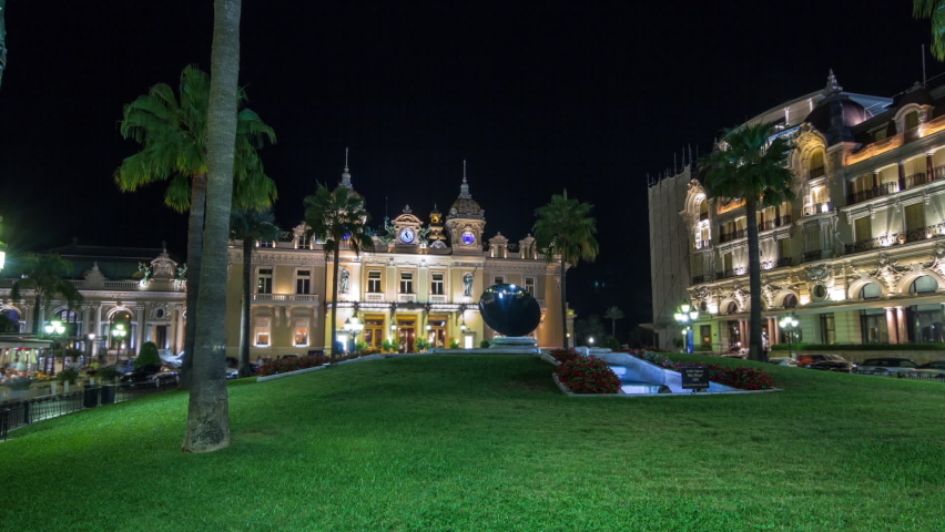 Square with Grand Casino in Monte Carlo night hyperlapse timelapse, Monaco. Historical illuminated buildings around. Clock on the top. Palms on the side. Royalty-Free Stock Footage #1089770901