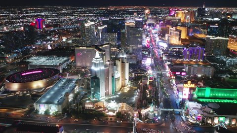 Las Vegas Strip, Nevada, Apr. 2022. Cinematic aerial of famous New York hotel with Liberty Statue and roller coaster in neon lights. Entertainment gambling capital with casinos and 5-stars resorts 4K