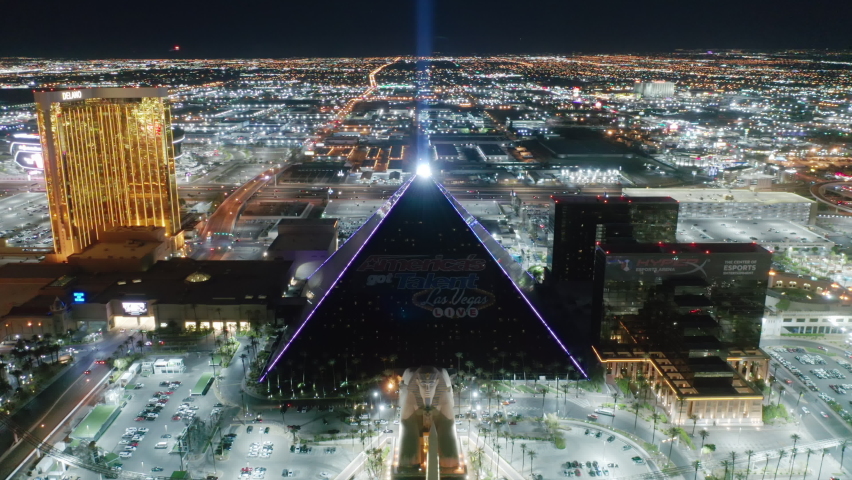 Las Vegas at night, Nevada, Apr. 2022. USA tourism concept, entreatment capital for adults, best weekend vacation idea to relax. Scenic Luxor Pyramid hotel with ray of light shining brightly at night