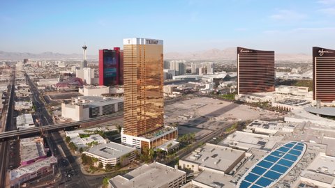 Las Vegas Strip, USA Apr. 2022. Scenic view on world famous 5 stars resorts and hotels in gentle golden hour light. Impressive shiny golden Trump hotel with Encore and WYNN hotels on motion background