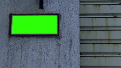 Street Name Sign with Green Screen on the Wall of an Old House. Night Time. Close Up.